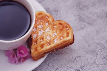 Waffle Biscuits in Shape of Heart with Cup of Coffee on Wooden Background for Valentines day, top view