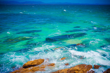 Beautiful crystal clear ocean water with rocks