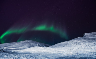 Obraz na płótnie Canvas The polar arctic Northern lights aurora borealis sky star in Norway Svalbard in Longyearbyen city the moon mountains