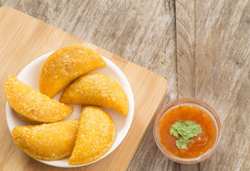 Colombian empanada with spicy sauce