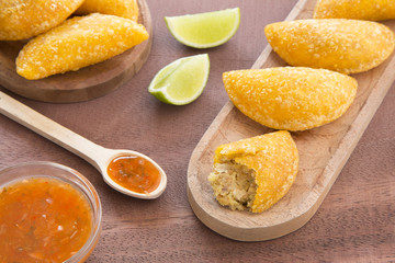 Colombian empanada with spicy sauce