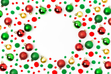Frame  made of red and green Christmas balls on white background. Flat lay, top view
