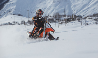Fototapeta na wymiar Enduro Snowbike Snowmobile journey with dirt bike high in the mountains