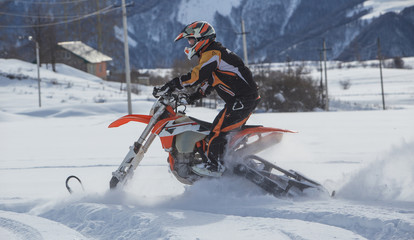 Enduro Snowbike Snowmobile journey with dirt bike high in the mountains