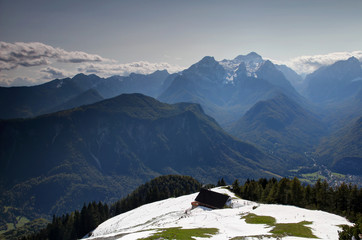 Jagged Julian Alps with Triglav Rjavina and forested Jerebikovec peaks, Vrata  Kot and Sava valleys, Triglav National Park, in sunny autumn from snowy meadow on Dovska Baba Karavanke range Slovenia © nogreenabove2k