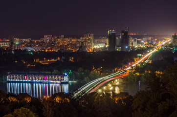 Lights of night Kyiv, bridge across the river, hotel and restaurant