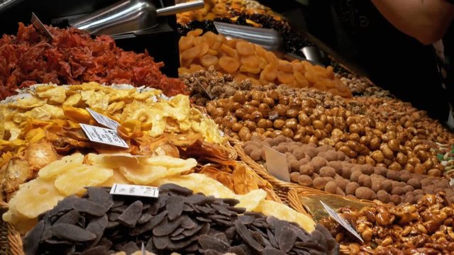 Showcase with Dried Fruits and Nuts at a Market in La Boqueria. Barcelona. Spain. Nuts, dry fruits on display at the market on the showcase. Stall with Various dried fruits at Mercat de Sant Josep.