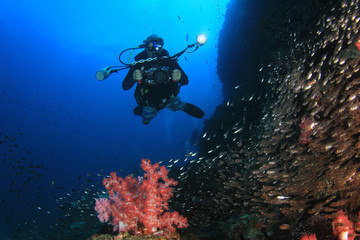 Naklejka na ściany i meble Underwater photographer scuba diving