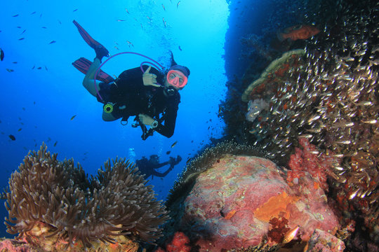 Scuba diver. Young woman scuba diving on coral reef