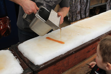 Making a maple syrup candy on the snow.  Maple syrup festival. 