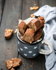 Classic chocolate Italian biscotti with nuts in a beautiful vintage mug with stars. Copy Space. View blank space for text. Place for text. Food photo.  top view