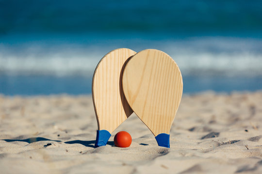 Beach tennis, beach paddle ball, matkot. Beach rackets and ball on the beach