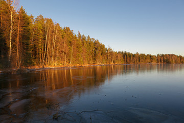 Forest frozen lake and sunset light nature Finland