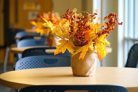 Close Up On Autumn Decoration Leaf And Flower In Vase On The Table