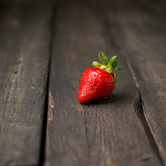 Fresh strawberries on a wooden vintage background. Place for text