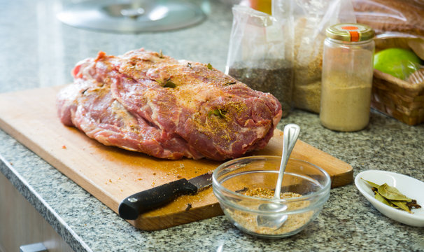 man add spices to the meat for preparing