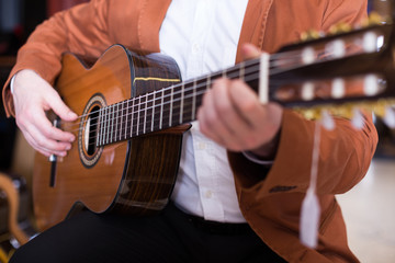 Professional guitarist practicing on guitar