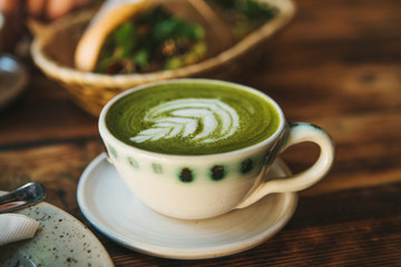 Close-up ceramic cup with green tea called Matcha