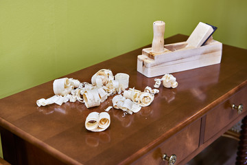 Joiner planer and wood shavings on furniture