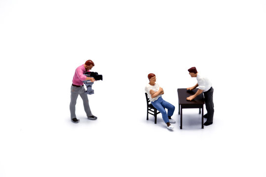Miniature people  : depicting a situation of a conflict or tension between two men.with cameraman