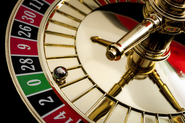 Gambling, casino games and the gaming industry concept with zero the winning number, 0 is the only green number on this roulette wheel