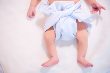 Feet of newborn baby in diaper with copyspace