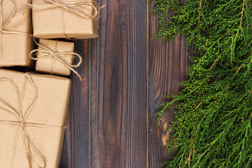 Many gift box on dark rustic wooden background with copy space. Christmas fir tree branches. Christmas conceps