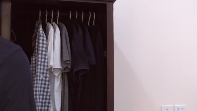 The Man opened the closet with clothes 4K
