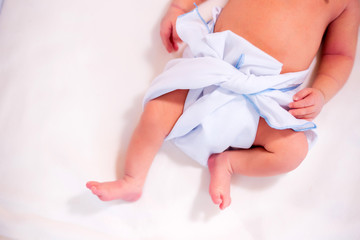 Feet of newborn baby in diaper with copyspace