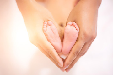 Fototapeta premium Parent holding in the feet of newborn baby.