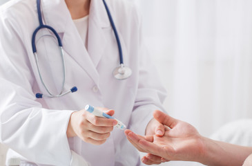 doctor measuring blood sugar young men