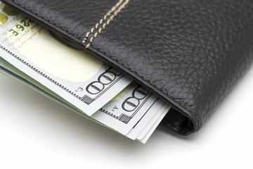 Black leather wallet with cash dollars on a white background.