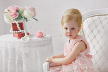 Fototapeta na wymiar Cute little girl in a pink dress. Portrait on a white background in a romantic vintage style