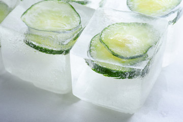 Frozen cucumber slices in the ice cubes
