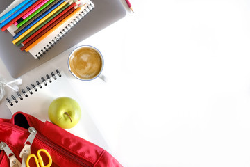 School backpack and school supplies on white wood table background. Back to school concept.