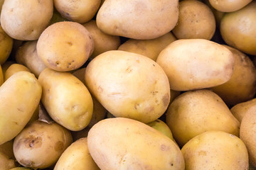 fresh organic potatoes on stand in supermarket