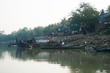 Poor fisherman boat in cambodia with waste