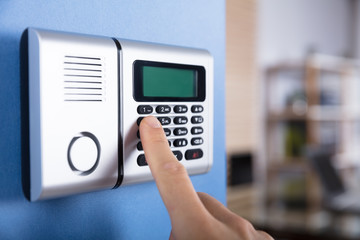 Person's Finger Entering Code In Security System
