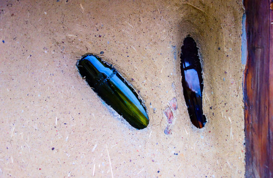 Natural building with clay and sand with glass bottles