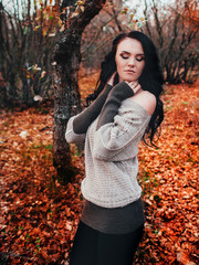 Pretty brunette walking in a forest