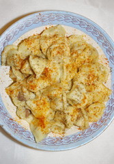 dumplings in a plate with red pepper and butter