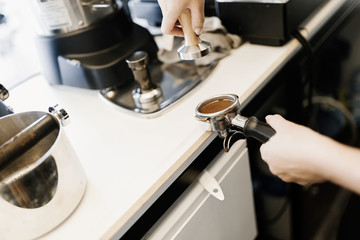 Barista making fresh coffee with machine