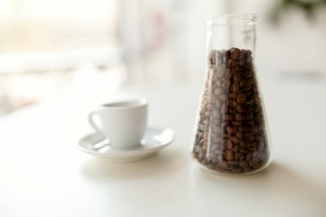 Coffee beans on table with cappuccino