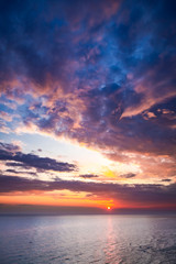 Wonderful dusk over calm ocean in summer with sun