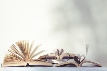 Open books and glasses on the table