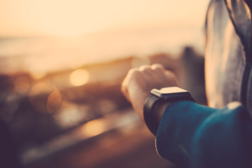  Close up of man using his smart watch outdoors