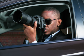 Detective Sitting Inside Car Photographing