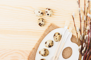 Palette with quail eggs and twigs willow