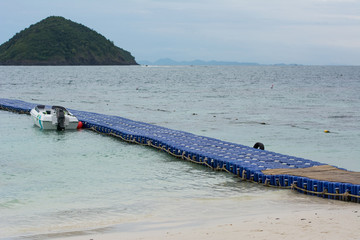 Line of blue plastic float buoys on the ocean. The floating piers walk way pontoon in the sea.