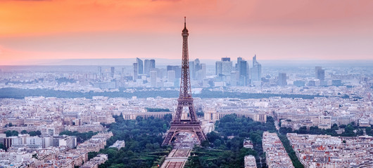 Paris, France. Panoramic view of Paris skyline with Eiffel Tower in the center. Amazing sunset scenery with dramatic sky.